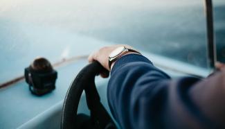 Person steering a boat.