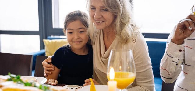 Elderly woman and grandchild having dinner together