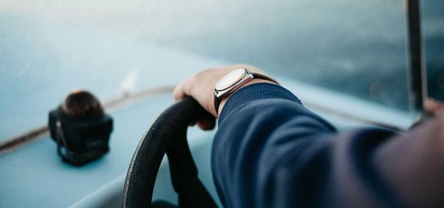 Person steering a boat.